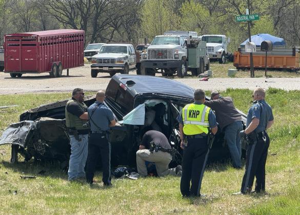 Law enforcement officers investigate the pickup and crash scene near the southern entrance to the Washington Industrial Park on Monday. The pickup came to rest in the ditch after it rolled and flipped after running into a ditch during a high speed chase along K15. Photos by DAN THALMANN / WCN